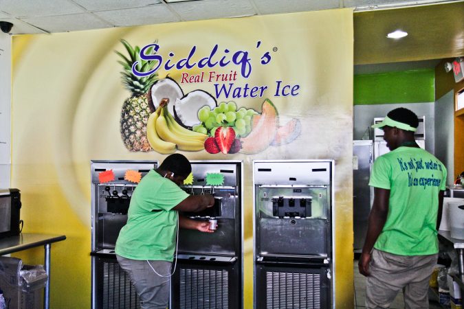 Dean Maitir and Hamir Jews serve ice cream at Siddiq’s Water Ice in West Philadelphia. (Kimberly Paynter/WHYY)