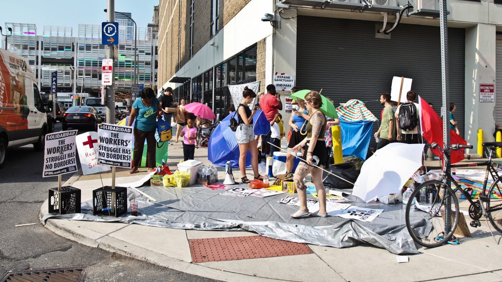 Demonstrators protest ICE outside of the office at Eighth and Cherry streets in Philadelphia. (Kimberly Paynter/WHYY)