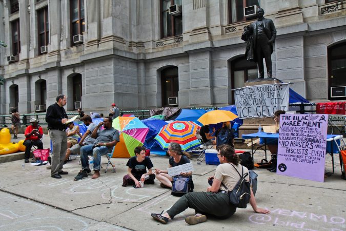 Immigration policy protesters have moved from the ICE headquarters at Eighth and Cherry streets to City Hall and are asking Philadelphia Mayor Jim Kenney to end an agreement with ICE. (Kimberly Paynter/WHYY)