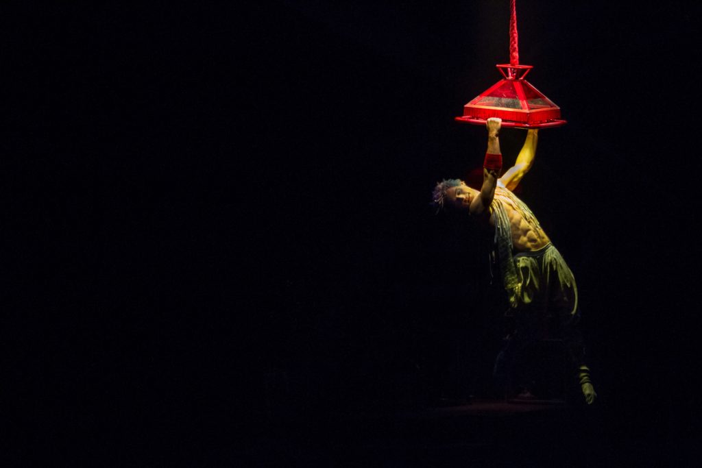 675 Joey Arrigo, as the character Waz, performs on a lighting fixture in