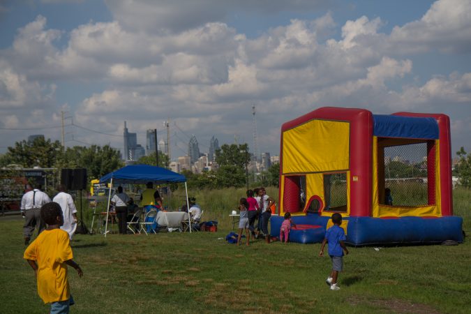 Kids enjoy a deejay and a bouncy house at the WURD event at Bartram’s Garden. (Kimberly Paynter/WHYY)