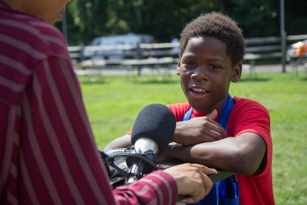 7 26 18 k paynter wurd event violence (1 of 1) Eryn Greenwood, 10, from Eastwick, shares an experience he had with gun violence at the WURD event at Bartram’s Garden. (Kimberly Paynter/WHYY)