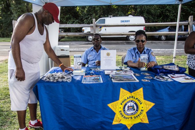 Philadelphia Police hand out gun locks at the WURD event at Bartram’s Garden. (Kimberly Paynter/WHYY)
