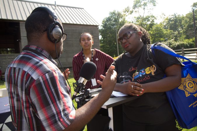 Marissa Bowlerss, from Southwest Philadelphia, shares her experience with violence at the the WURD event at Bartram’s Garden. (Kimberly Paynter/WHYY)