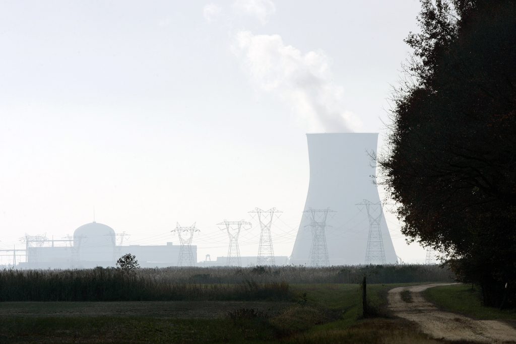 Nuclear Community power plant A large cooling tower and other buildings at the Salem nuclear power plant known as Artificial Island can be seen near a farm in Lower Alloways Creek Township, N.J. The project calls for connecting Delaware’s electric grid to powerlines adjacent to the plant via a 230-kilovolt transmission line buried in the sediment underneath the Delaware River. (AP Photo/Mel Evans)