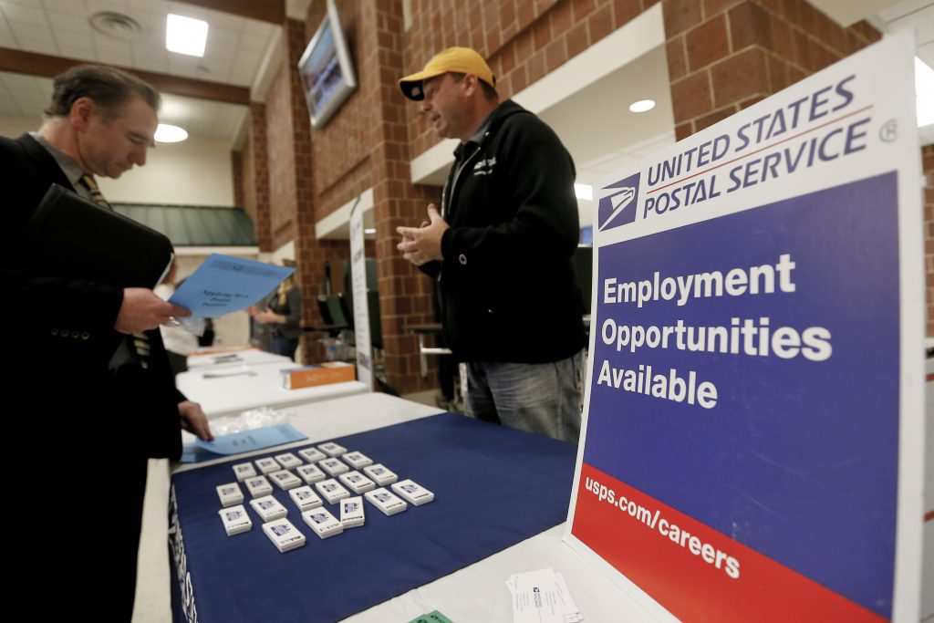 Unemployment Benefits In this Thursday, Nov. 2, 2017, photo, a recruiter from the postal service, right, speaks with an attendee of a job fair in Cheswick, Pa. (AP Photo/Keith Srakocic)