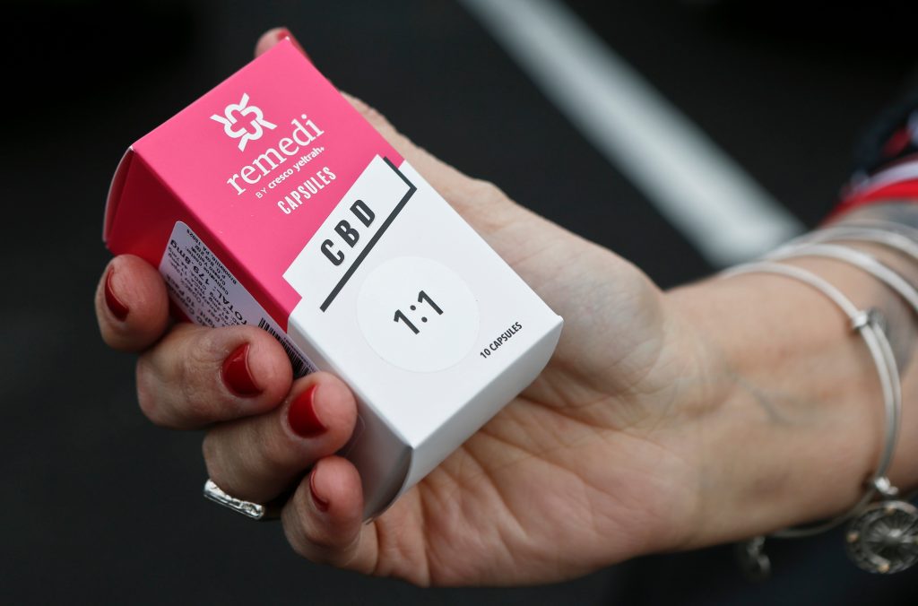 Marijuana Opioids In this Thursday, Feb. 15, 2018 file photo, a woman holds the prescribed medical marijuana product used to treat her daughter's epilepsy after making a purchase at a medical marijuana dispensary in Butler, Pa. Two new studies released on Monday, April 2, 2018 suggest that legalization of marijuana may reduce the prescribing of opioids. (AP Photo/Keith Srakocic)