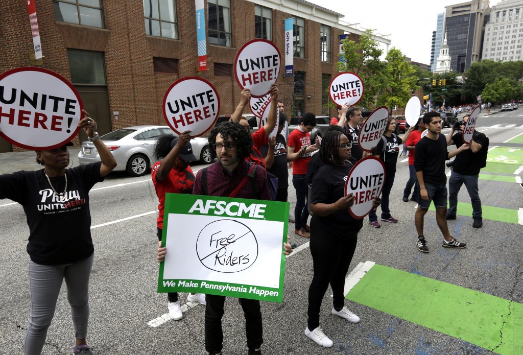Supreme Court Union Fees Union activists stand in the road as they participate in a protest by the Philadelphia Council AFL-CIO Wednesday June 27, 2018 in Philadelphia. The protesters denounced Wednesday's U.S. Supreme Court ruling that government workers can't be forced to contribute to labor unions that represent them in collective bargaining, dealing a serious financial blow to organized labor. (AP Photo/Jacqueline Larma)