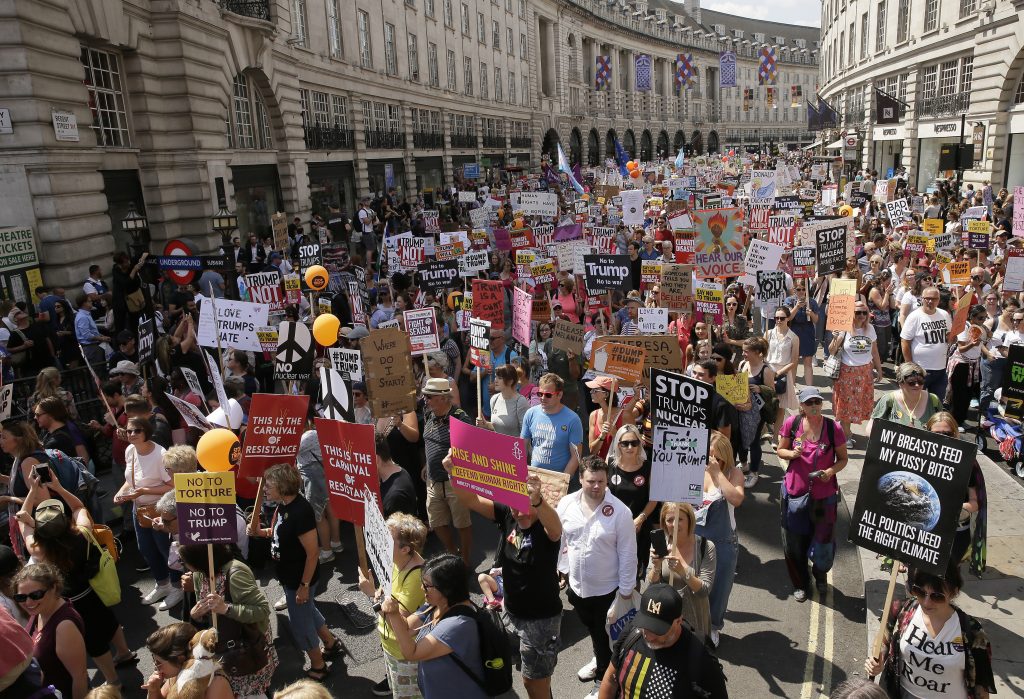 Britain Trump Visit Protestors hold banners during a march opposed to the visit of U.S. President Donald Trump in London, Friday, July 13, 2018. (AP Photo/Tim Ireland)