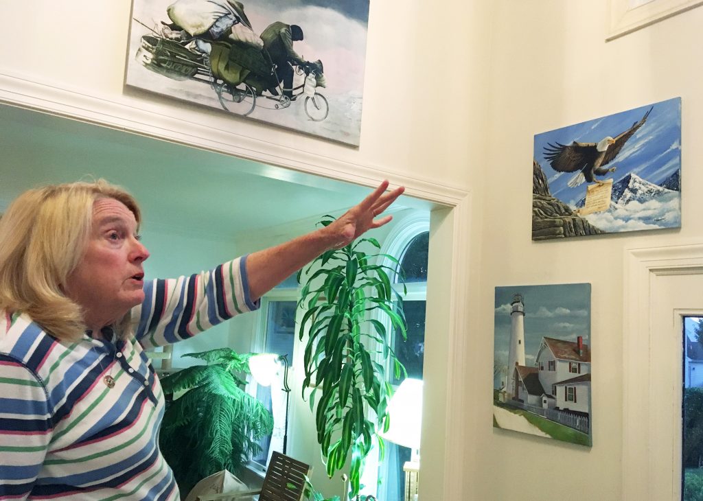 Prison Disturbance Hostage Former Department of Correction counselor Patricia May describes some of the many paintings by Delaware prison inmates that decorate her home in Hockessin, Del., Monday, July 16, 2018. May, a state corrections counselor who was taken hostage during a deadly riot at Delaware's maximum-security prison, says prison officials are to blame. (AP Photo/Randall Chase)