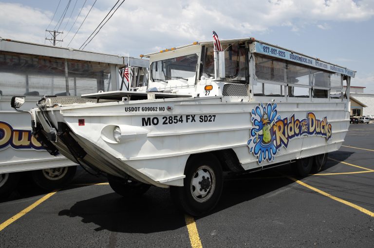 A duck boat sits idle in the parking lot of Ride the Ducks, an amphibious tour operator in Branson, Mo. Friday, July 20, 2018. The amphibious vehicle is similar to one of the company's boats that capsized the day before on Table Rock Lake resulting in 17 deaths. (Charlie Riedel/AP Photo)