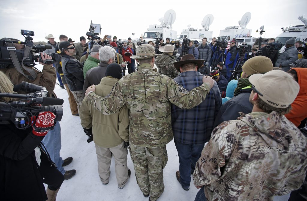 Ammon Bundy Members of the group occupying the Malheur National Wildlife Refuge headquarters hug after Ammon Bundy, center, left, one of the sons of Nevada rancher Cliven Bundy, spoke with reporters during a news conference Monday, Jan. 4, 2016, near Burns, Ore. The group calls itself Citizens for Constitutional Freedom and has sent a