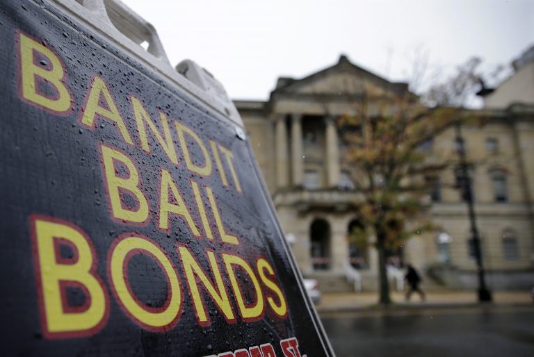 A sign is seen outside a bail bondsman across the street from Mercer County criminal courthouse Thursday, Oct. 23, 2014, in Trenton, N.J.