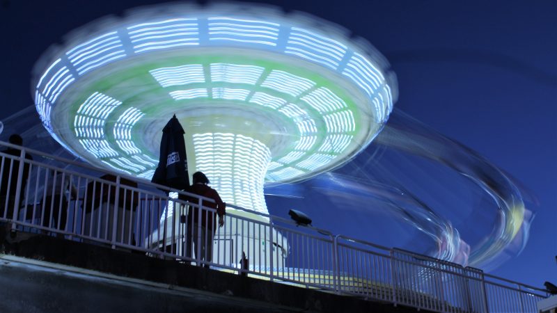 The swing at Gillian’s Wonderland Pier on the Ocean City Boardwalk lights up as the sun sets. (Bill Barlow/for WHYY)