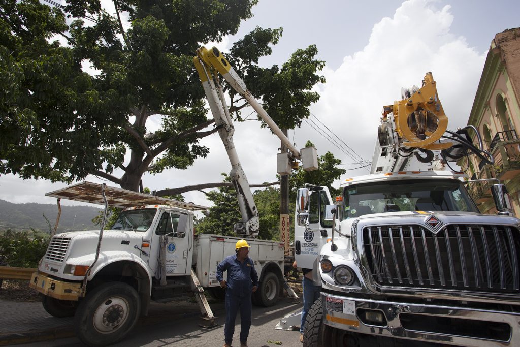 IMG_4333 Workers from the power company, PREPA, work on a downed line in Utuado. Branches from a tree fell on the line, breaking it and causing a transformer to explode. (Irina Zhorov/WHYY)