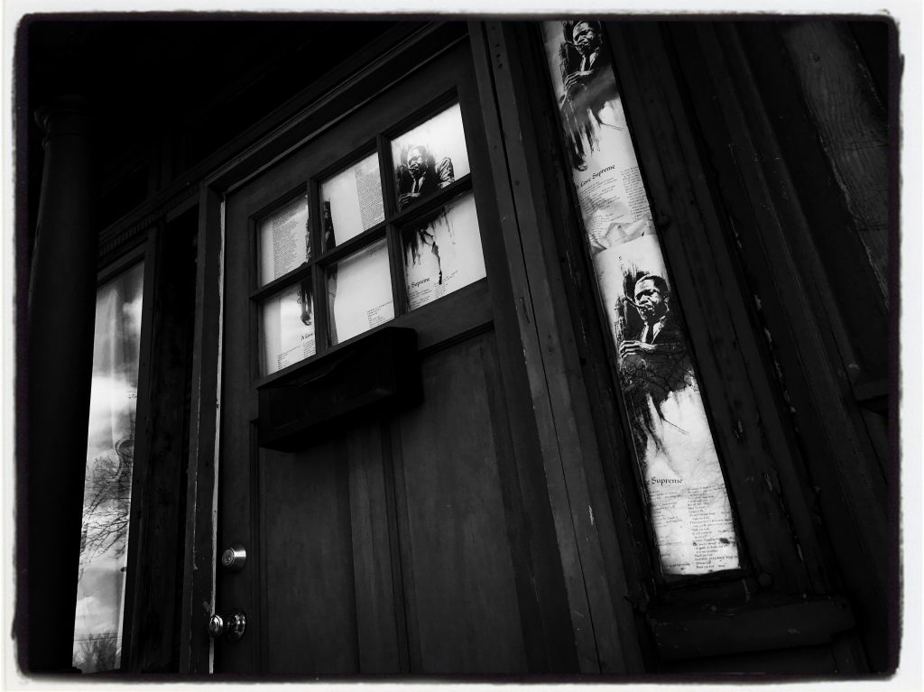 Liner notes to Coltrane's masterpiece, "A Love Supreme" are taped to the small windows on either side of the front door.