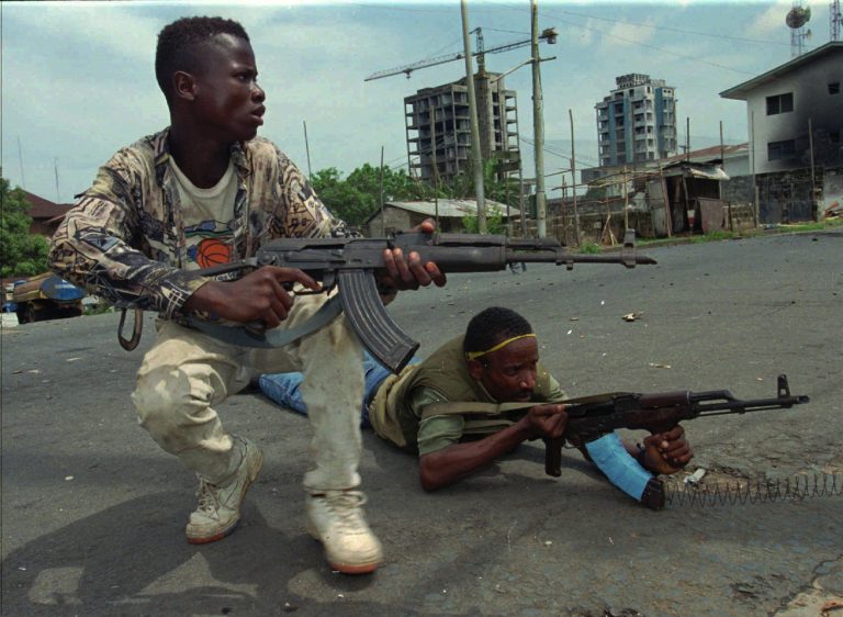 LIBERIA-768×562 Fighters from the United Liberation Movement of Liberia (ULIMO) shoot their way through downtown Monrovia, LIberia Tuesday, April 16, 1996. (AP Photo/Jean-Marc Bouju)