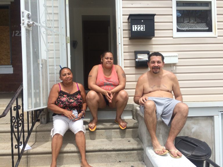 Ana Marrero, Milagros Soto, and Pablo Cuevas catching a cool breeze on the stoop of their home in Hunting Park. (Catalina Jaramillo/WHYY News)