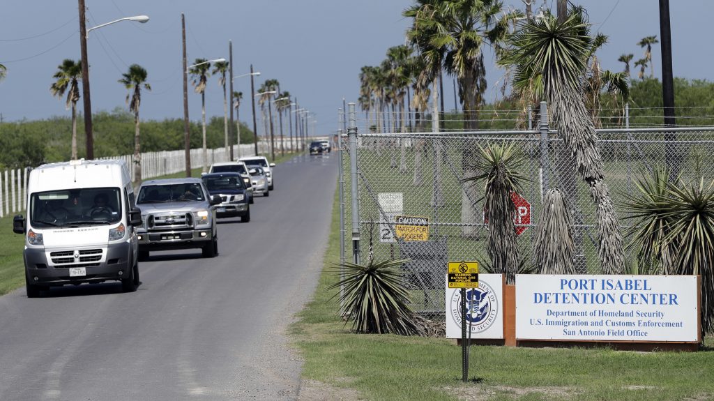 All day, unmarked white vans and chartered buses carrying the migrant children released from shelters across the country roll into the parking lot of the Port Isabel Detention Center in south Texas. All day, unmarked white vans and chartered buses carrying the migrant children released from shelters across the country roll into the parking lot of the Port Isabel Detention Center in south Texas. (David J. Phillip/AP)