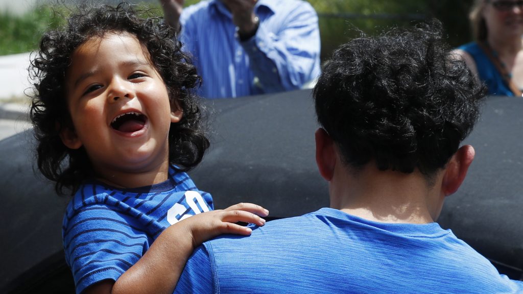 Ever Reyes Mejia, of Honduras, carries his son to a vehicle after being reunited and released by United States Immigration and Customs Enforcement in Grand Rapids, Mich. Ever Reyes Mejia, of Honduras, carries his son to a vehicle after being reunited and released by United States Immigration and Customs Enforcement in Grand Rapids, Mich. (Paul Sancya/AP)