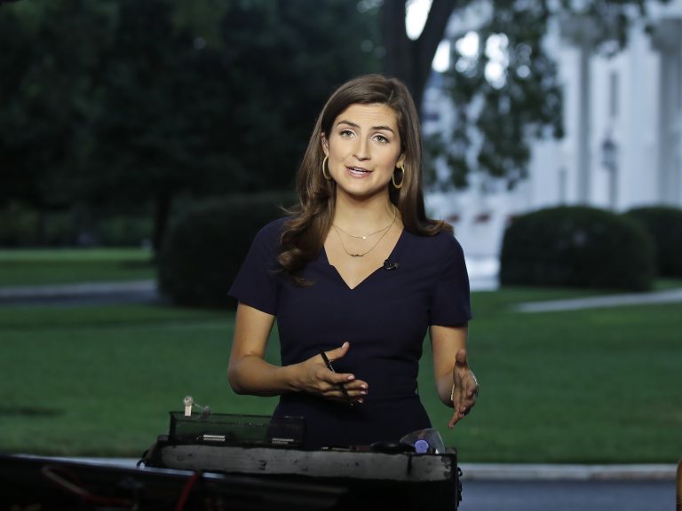 CNN White House correspondent Kaitlan Collins talks during a live shot in front of the White House on Wednesday. Collins says the White House denied her access to an open press event because officials found her earlier questions to the president 