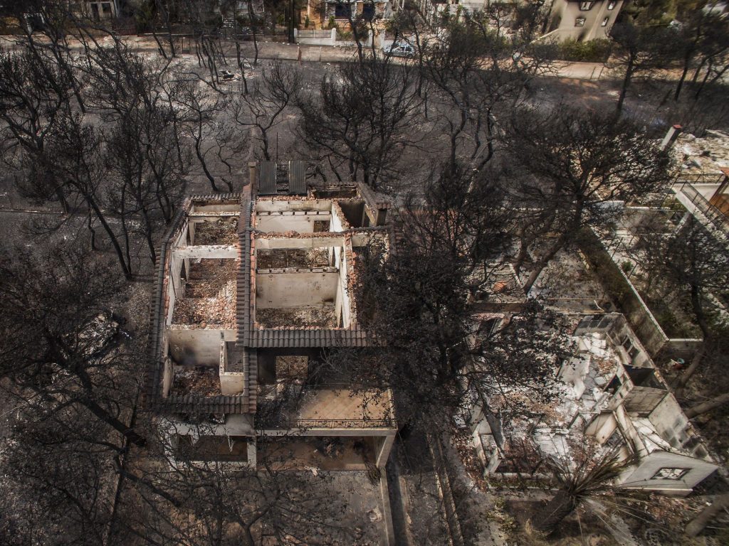 An aerial view shows burned-out houses after a wildfire hit the village of Mati, near Athens. The raging fires have killed at least 50 people in Greece, devouring homes and forests as terrified residents fled to the sea to escape the flames. An aerial view shows burned-out houses after a wildfire hit the village of Mati, near Athens. The raging fires have killed at least 50 people in Greece, devouring homes and forests as terrified residents fled to the sea to escape the flames. (Savvas Karmaniolas/AFP/Getty Images)