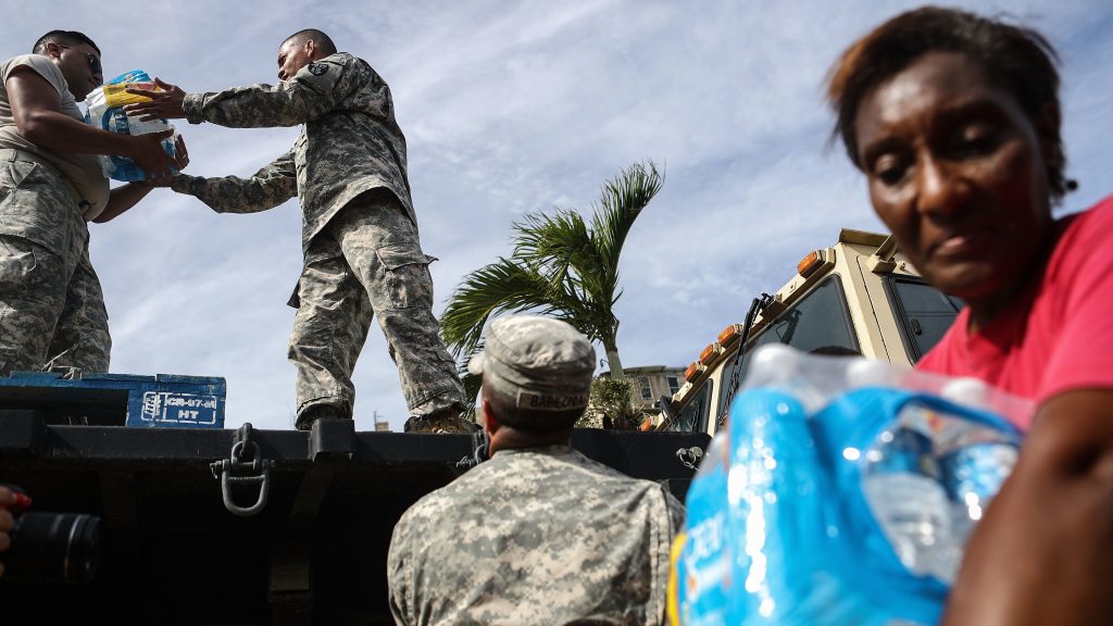 U.S. Army soldiers pass out water, provided by FEMA, to residents in a neighborhood without grid electricity or running water in San Isidro, Puerto Rico, on Oct. 17, 2017. U.S. Army soldiers pass out water, provided by FEMA, to residents in a neighborhood without grid electricity or running water in San Isidro, Puerto Rico, on Oct. 17, 2017. (Mario Tama/Getty Images)