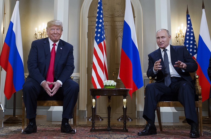 Donald Trump, Vladimir Putin Russian President Vladimir Putin, right, makes a statement as U.S. President Donald Trump, left, looks on at the beginning of a meeting at the Presidential Palace in Helsinki, Finland, Monday, July 16, 2018. (AP Photo/Pablo Martinez Monsivais)