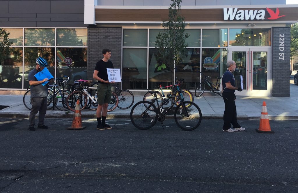 traffic-safety-advocates-form-a-human-protected-bike-lane-on-22nd-street-to-protest-for-better-bike-infrastructure.original Customers often park in the bike lane while they run into the Wawa on 22nd Street, which opened a few months ago. (Jim Saksa/WHYY News)