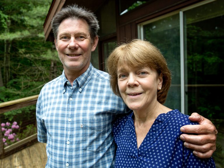Bea and Doug Duncan outside their home in Natick, Mass. The coaching they got from the Community Reinforcement and Family Training program, they say, gave them tools to help their son Jeff stick to his recovery from drug use. He's 28 now and has been sober for nine years. (Robin Lubbbock/WBUR)