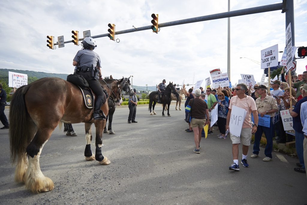 2018 08 02-n piserchio- 21 Police on horses gather a crowd of protesters towards the sidewalk on Highland Park Boulevard in Wilkes-Barre, PA. Approximately 300 protesters showed up on August 2, 2018, outside of the Make America Great Again rally. (Natalie Piserchio for WHYY)