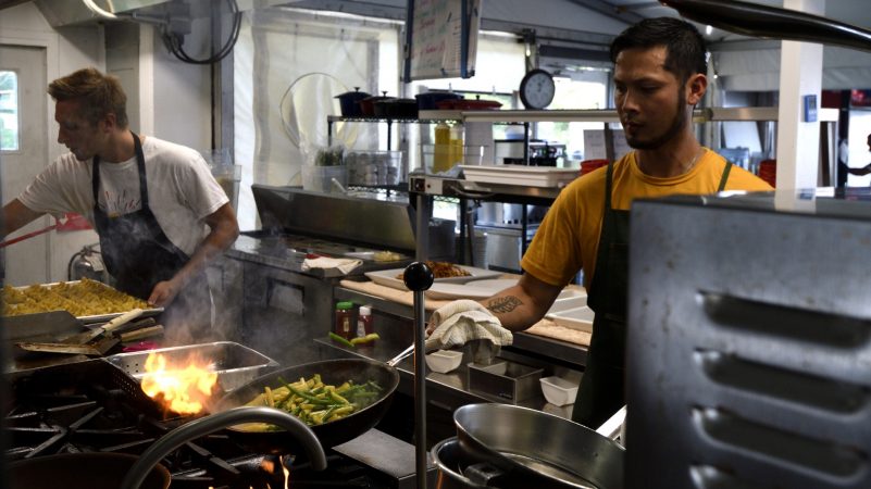 Ahead of lunchtime, the three international chefs in the kitchen are busy preparing meals for performers at the restaurant of Cirque Du Soleil's VOLTA, in Oaks, Pa., on August, 8, 2018. (Bastiaan Slabbers for WHYY)