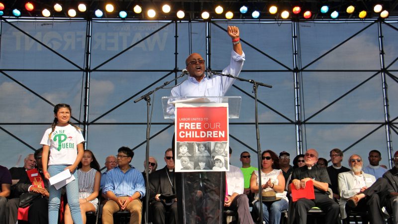 Ken Rigmaiden, president of the International Union of Painters and Allied Trades, acknowledges the crowd of about 2,000 union members at a rally at Penn's Landing. Rigmaiden was a key organizer of the event in support of immigrant families. (Emma Lee/WHYY)