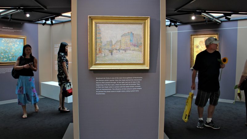 Visitors to the pop-up van Gogh museum at King of Prussia Mall explore the octagonal space where they can get up close to nine replicas of van Gogh masterpieces. (Emma Lee/WHYY)
