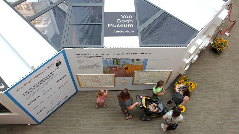 Children add color to a drawing of Vincent van Gogh's 