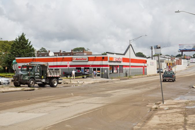 Cleanup crews on Marshall Road work to open the roads two hours after a flash flood overtook the Upper Darby area causing damages to businesses. (Kimberly Paynter/WHYY)