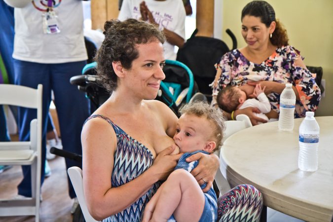 Rachel Utain-Evans breastfeeds her 15-month-old, Oliver, at the Big Latch event in Philadelphia. (Kimberly Paynter/WHYY)