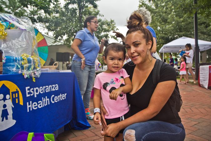 Joy Cruz and her daughter Alexandria, 2, attend the Big Latch breastfeeding event at Franklin Square Park in Philadelphia. (Kimberly Paynter/WHYY)