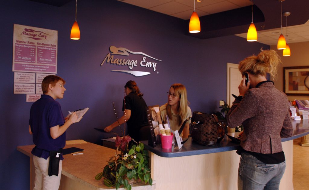 WELL BEING MALL MASSAGE 10/9 Receptionists check in a customer at a Massage Envy in this file photo (L.G. Patterson/AP Photo)