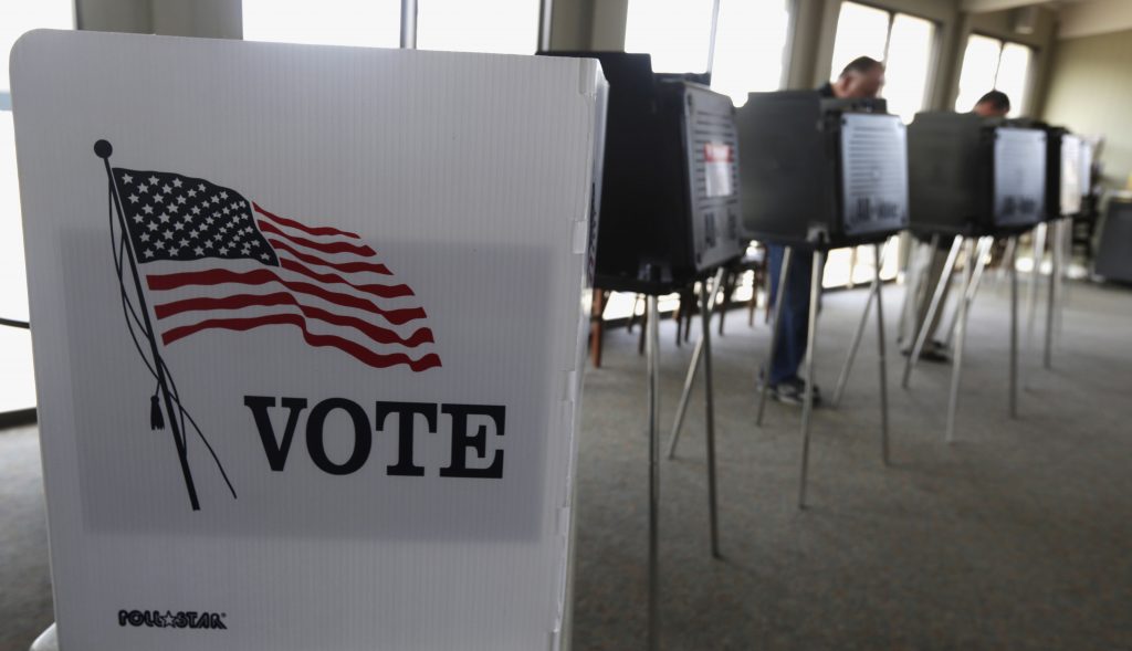 Voter Registrations In this March 18, 2014 file photo, voters cast their ballots. (M. Spencer Green/AP Photo, File)