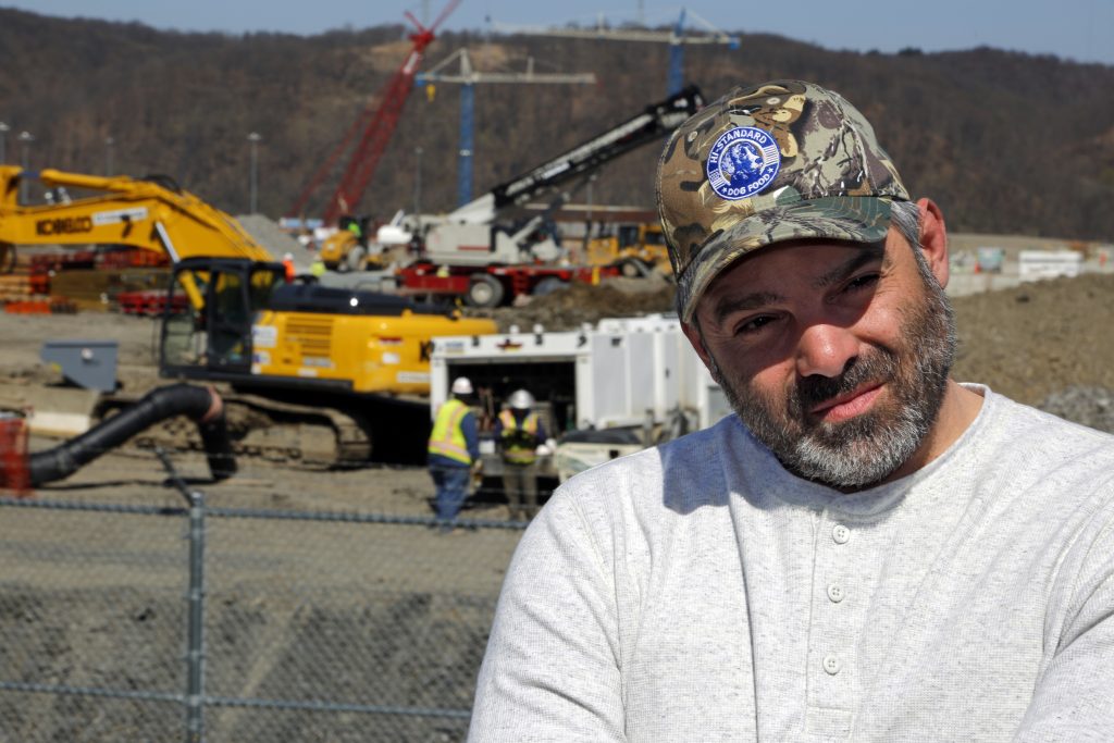 Chip Kohser In this April 30, 2018 photo, Chip Kohser, the Beaver county Republican chairman, stands overlooking the construction of a chemical plant on the banks of the Ohio River near Beaver, Pa., that will help convert natural gas into plastic, creating hundreds of jobs in an area that has seen population dwindle since the collapse in the 1980's of the steel industry. (AP Photo/Gene J. Puskar)