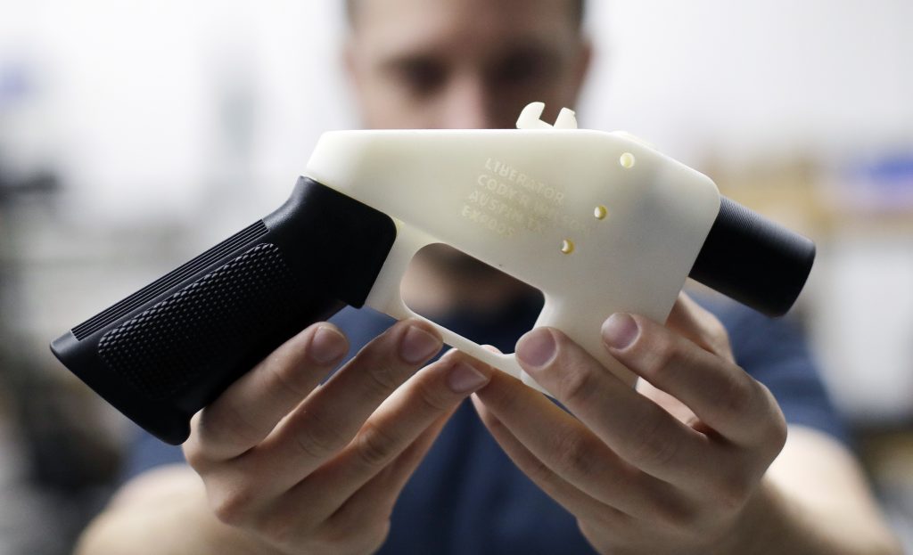 Cody Wilson In this Aug. 1, 2018, file photo, Cody Wilson, with Defense Distributed, holds a 3D-printed gun called the Liberator at his shop in Austin, Texas. A federal judge in Seattle heard arguments Tuesday, Aug. 21, 2018, on whether to block a settlement the U.S. State Department reached with a company that wants to post blueprints for printing 3D weapons on the internet. (Eric Gay/AP Photo)