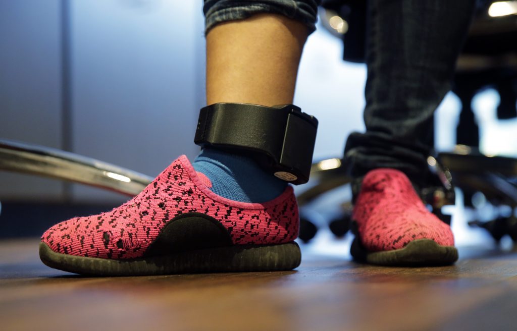 Ildra Medreano In this Monday, July 23, 2018, file photo, Immigrant seeking asylum Ildra Medreano wears an ankle monitor at a Catholic Charities facility not long after she was reunited with her son in San Antonio. Federal authorities' shift away from separating immigrant families crossing into the U.S. illegally now means that many parents and children are quickly released from custody only to be fitted with electronic monitoring devices, a practice that has spiked in recent years but which both the government and advocacy groups oppose for different reasons. (AP Photo/Eric Gay)