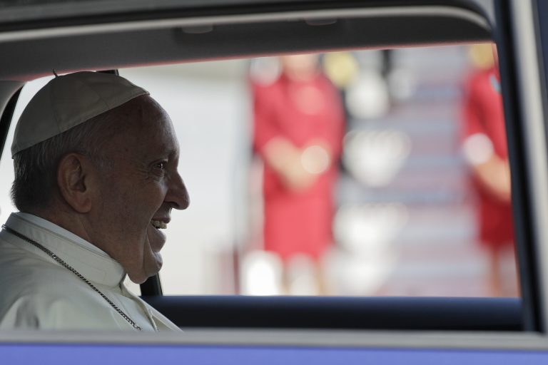 Pope Francis sits in a car