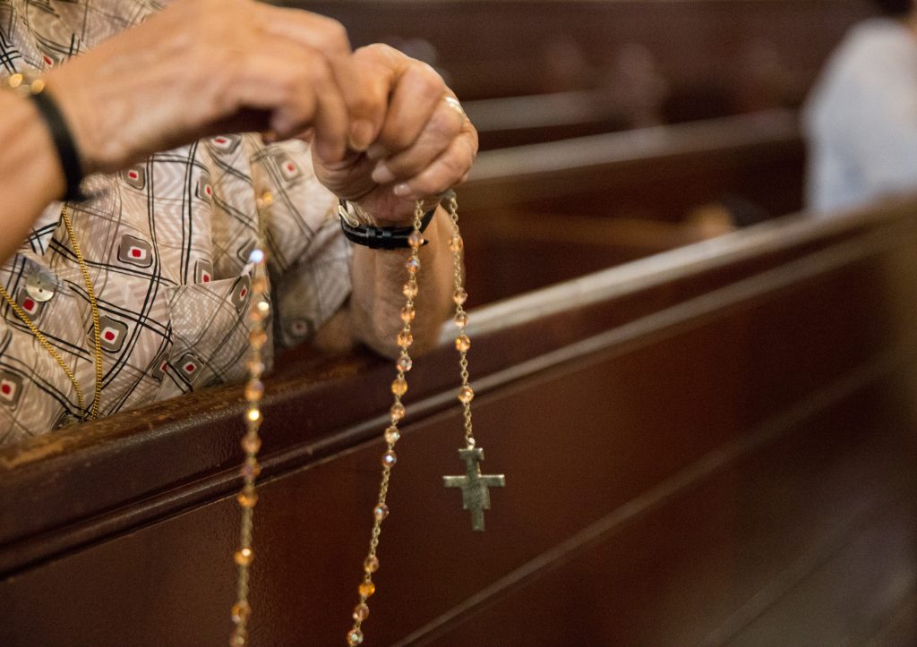 Holy Infancy Roman Catholic Bethlehem PA 08142018_02 Parishioners pray the Rosary at Holy Infancy Roman Catholic in Bethlehem, Pennsylvania after mass on Tuesday, August 14, 2018, the same day, Pennsylvania Attorney General released his two-year grand jury investigation into widespread sexual abuse and cover-up within six Catholic dioceses across the state. (Lindsay Lazarski/WHYY)