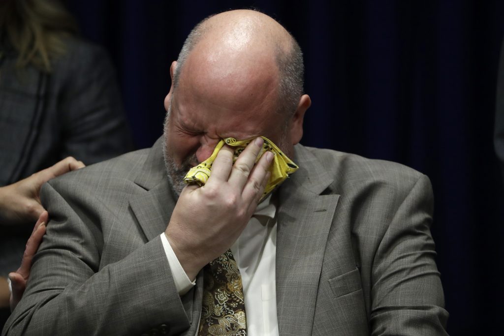 Pennsylvania Dioceses-Sex Abuse Investigation Former priest James Faluszczak, who says he was molested by a priest as a teenager, reacts as Pennsylvania Attorney General Josh Shapiro speaks during a news conference at the Pennsylvania Capitol in Harrisburg, Pa., Tuesday, Aug. 14, 2018. (AP Photo/Matt Rourke)