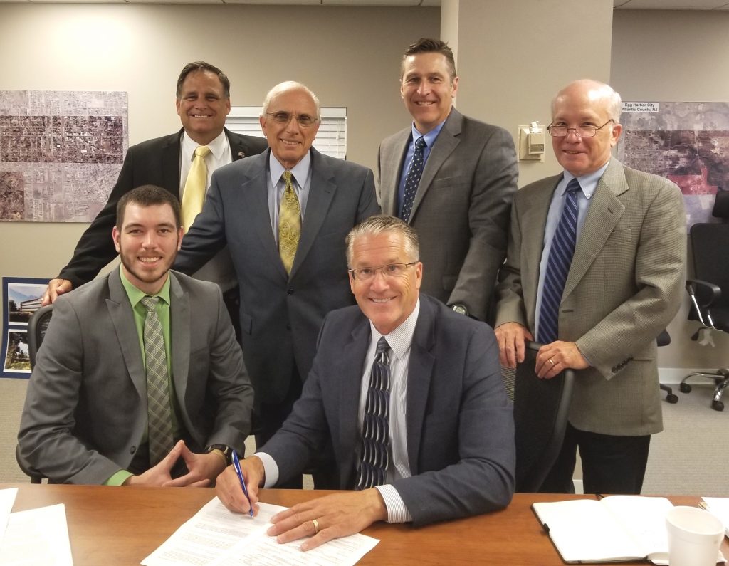RBDG contract signing Contract signing by ACEA Executive Director Lauren H. Moore Jr. with USDA loan specialist Joseph Henry (seated to left) and (standing, from left) Max Slusher, ACEA business development director; Michael Zumpino, Triad Associates chairman and CEO; Noel McGuire, ACEA business aviation representative; and Steve Kehs, Triad Associates vice president. (Provided)
