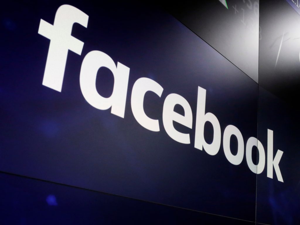 The logo for Facebook appears on screens at the Nasdaq MarketSite in New York. (Richard Drew/AP)