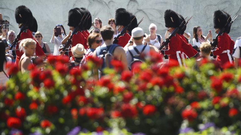 Spectators gather daily to watch the changing of the guard at Buckingham Palace in London. On Friday, a military band paid tribute to Aretha Franklin at the ceremony.
(Kirsty O'Connor/AP)