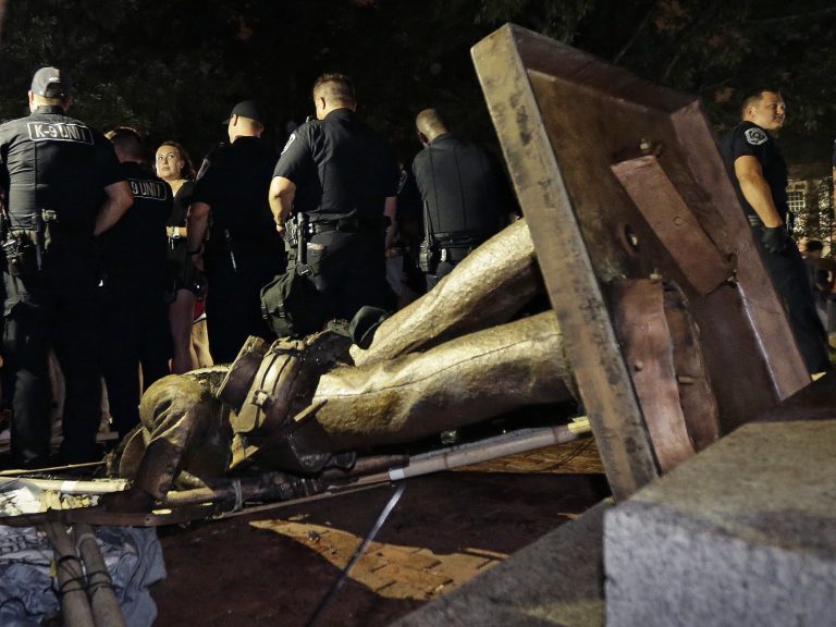 Police stand guard after the Confederate statue known as 